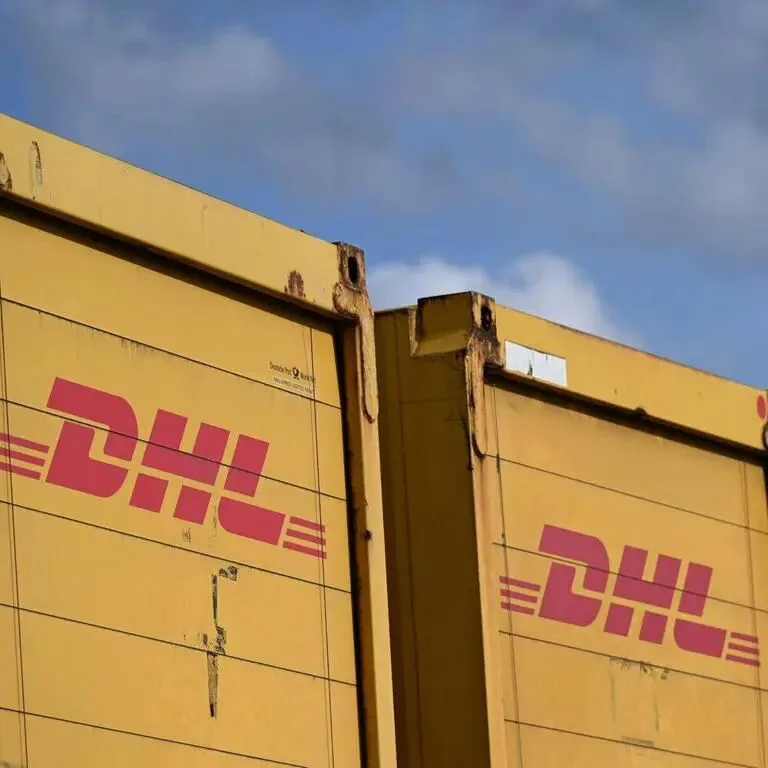 Container des Logistikers und Paketunternehmens DHL, das an der Börse Deutsche Post AG heißt, stehen vor dem Logistikzentrum von Amazon.
